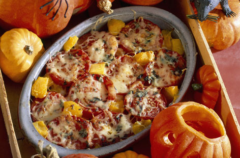 Celebrate Halloween with this hearty bake, which is bursting with flavour. The savoury flavours of the pumpkin are great when roasted with sweet tomatoes. Melt some cheddar on top for some oozy, cheesy goodness.