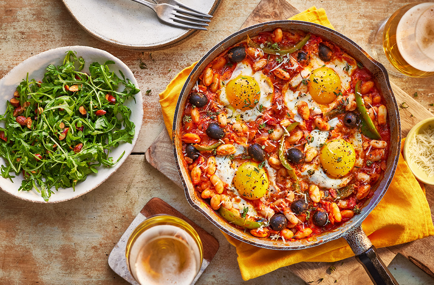 Baked eggs and Manchego with rocket and almond salad​ recipe