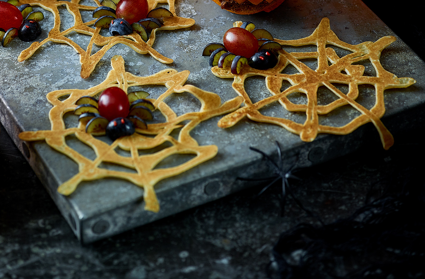 3-ingredient spider's web pancakes with fruity spiders recipe