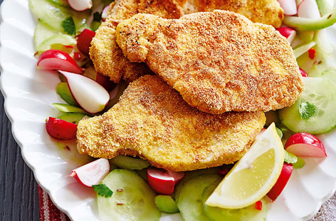 Rustle up this tasty salad of cucumber, radishes and celery topped with tender pork schnitzel and drizzled with a chilli, white wine vinegar and cumin dressing - it's a light but satisfying salad that can be made in just 30 minutes