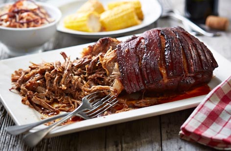 Pulled pork shoulder served with coleslaw and corn recipe