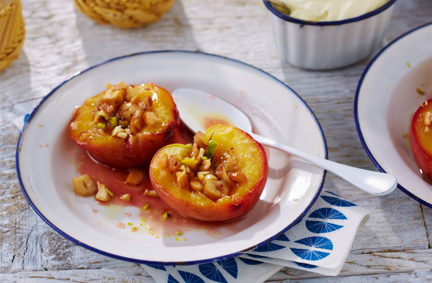Baked caramelised peaches with salted nuts recipe