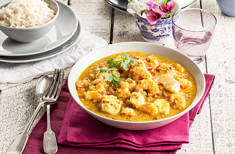 Try something new with this aromatic fish curry recipe, made with juicy king prawns, flaky white fish and fiery Southern Indian spices.