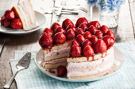 A lovely and light cake filled with ice cream and topped with fresh strawberries