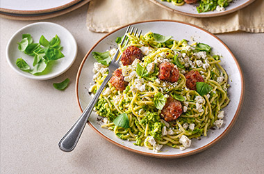 Sausage meatballs with pea pesto and spaghetti
