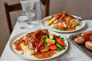 Sausage and cheesy mash with tomato gravy
