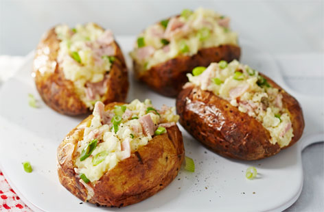 These delightful loaded potatoes are baked in the embers of a campfire before being stuffed with gooey Gruyère cheese, tasty smoked ham and creamy crème fraîche