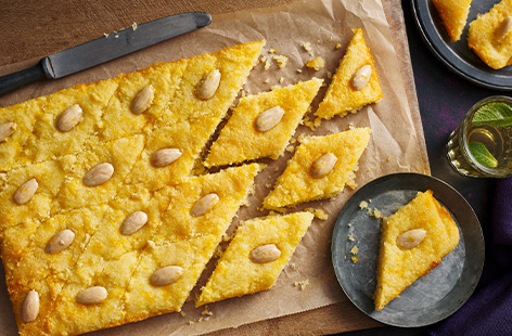 Originating in Egypt, Basbousa is a sweet semolina cake that is doused in an orange-flavoured syrup and topped with flaked almonds 