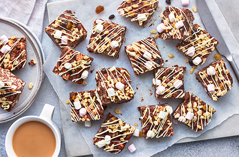 Rustle up this ridiculously tasty sweet treat in no time. With white, milk and dark chocolate, crispy rice snaps, gooey marshmallows, and chewy dried fruit, this rocky road recipe is seriously easy. The hardest part? Waiting for them to set before you can tuck in!