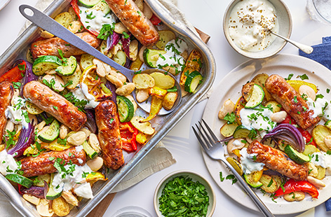 Let the oven do all the work with this easy Greek-style sausage traybake. Drizzle your veg with a garlic, lemon and oregano oil, then roast with sausages until golden. Serve with a dollop of feta yogurt. Use any leftovers to make our Greek sausage pittas for dinner tomorrow.