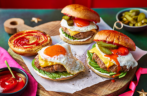 Recreate a takeaway breakfast bap from the comfort of home with our twist on the cult favourite. Sausages, eggs, cheese, gherkins and avocado are stuffed inside a sweet brioche bun with lashings of sauce. Napkins advisable.  