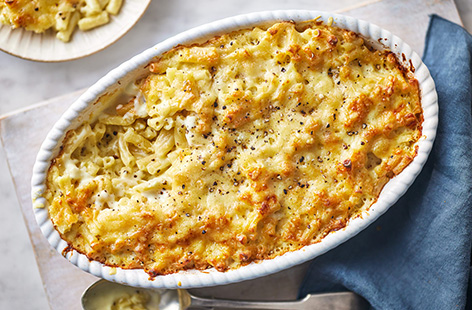 An all American favourite, this creamy, cheesy pasta bake is a family mealtime classic. Cooked macaroni pasta is stirred into a white sauce with mustard, Cheddar and Parmesan, then grilled until the top is golden and crispy. Give this macaroni and cheese recipe a go, you won't be disappointed!