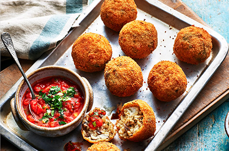 Fancy making arancini but short on time? Try this cheat's veggie version using readymade risotto and arrabbiata sauce. Stuffed with mozzarella and deep-fried to crispy perfection, this Sicilian street food makes a delicious starter, snack or light meal.