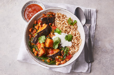 This colourful vegan curry is sure to liven up your midweek meals. Aubergine, spinach and black-eyed beans are cooked in a lightly spiced tomato sauce. Serve with brown rice and a dollop of natural yogurt - delicious!
