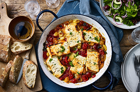Try this baked feta for a delicious summer lunch al fresco. Creamy feta is drizzled with honey and baked until melting and golden on a rich tomato and roasted pepper sauce. Serve with a fresh cucumber salad and plenty of ciabatta to soak up all the juices.