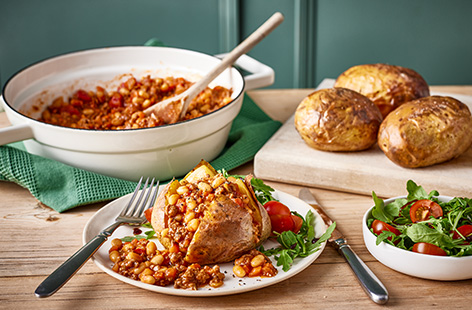 These jacket potatoes filled with a veg-packed bean and beef ragu makes a hearty and warming dinner