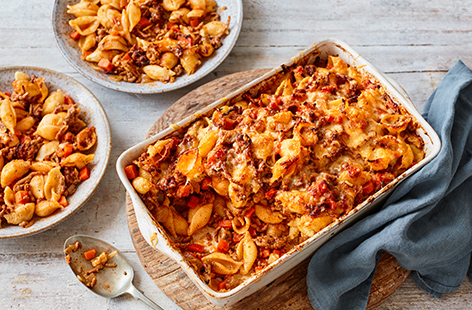 Spaghetti Bolognese is a timeless family favourite - make it even better with this hearty Bolognese pasta bake recipe. With plenty of hidden veg and a melting cheese topping, this baked pasta with mince is the perfect wallet-friendly way to feed the whole family. You could even use leftover Bolognese to make it speedier!