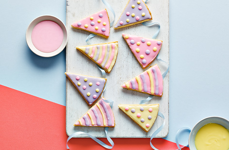 Bright and cheerful shortbread biscuits decorated with bunting icing really signals party season