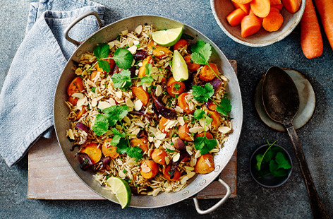 This warmly spiced carrot pilaf has so much going for it. It's healthy for a start, yet comforting; suitable for veggies and vegans, but everyone will enjoy it; you cook it in one roasting tin – there's no need to cook the rice separately. Finally, it's vibrant, flavour-packed and affordable. Need we say more? 