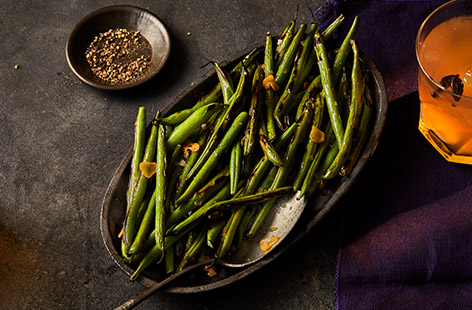 Dry-frying green beans gives a distinctive char, adding texture and flavour. Toss them in a garlicky oil and sprinkle with smoked salt for a winning side.