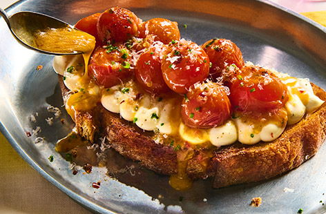 This isn’t your average cheese and tomatoes on toast. Sourdough toast is topped with lemony cream cheese followed by lightly charred, garlicky buttery tomatoes. Finished with a grating of Parmesan, it makes a lovely lunch.
