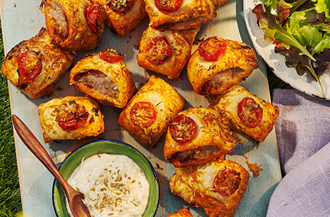 Upgrade your sausage rolls with these spicy bites featuring punchy 'nduja paste and served with a fragrant and creamy dip. Fab for picnics or a super summer spread. 