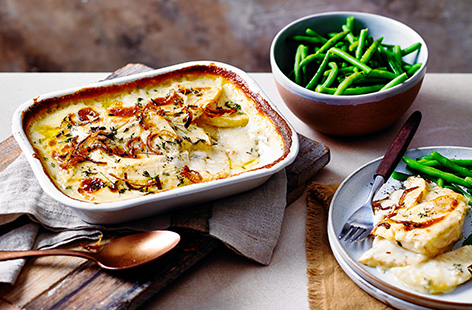 A fan of classic cauliflower cheese? Try this cheesy celeriac bake recipe for a twist on this winter comfort food. Wedges of roasted celeriac are coated in a rich, melting Cheddar sauce and scattered with crispy onions for some extra crunch.