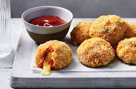 Melting Cheddar cheese, spicy pepperoni, creamy mash - these cheesy pizza balls have it all. Using ready made mashed potato for a clever shortcut, these cheese-filled croquettes are coated in breadcrumbs and baked until golden and crisp.