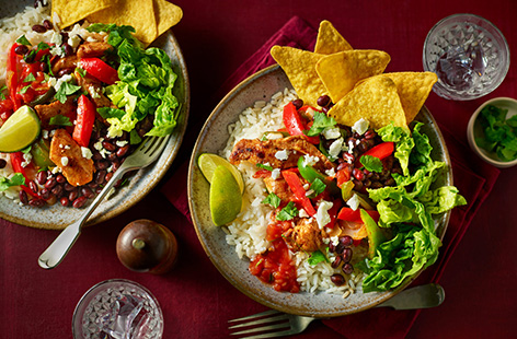 Looking for a full-of-flavour dinner that serves two? Look no further than these chicken fajita rice bowls. Tinned black beans and frozen veggies and chicken make this Mexican-inspired meal easy, colourful and tasty. Top with crumbled feta and zingy salsa, then serve with salted tortilla chips for a flavour fiesta! 