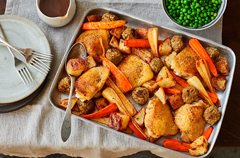 Cooking a roast has never been easier with this chicken and stuffing traybake recipe. All the best elements of a Sunday roast are cooked on one tray – crispy chicken, golden roasties, colourful veg and herby stuffing balls.