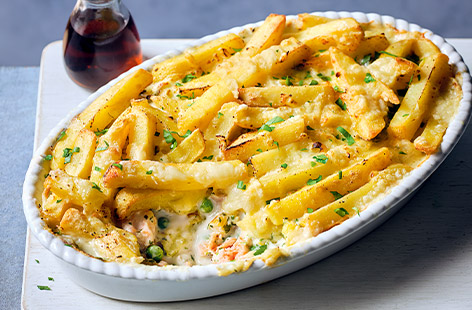 Try a new twist on fish and chips with this surprising fish pie recipe with spring onions, parsley and peas