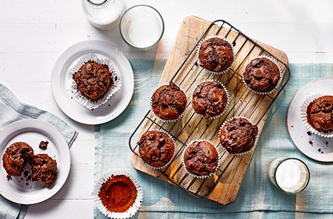 Bake a batch of this fluffy chocolate muffins recipe, studded with melting chunks of dark chocolate, for a crowd-pleasing bake - pack up for picnics or save for an afternoon treat.