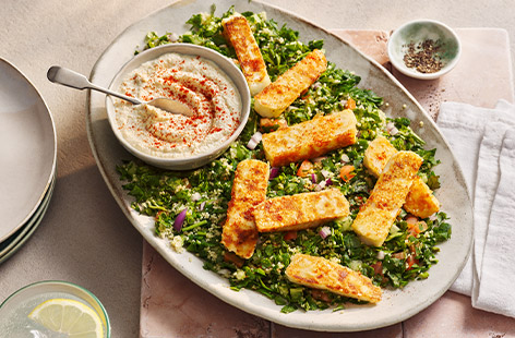 Use up any fresh herbs you have in your fridge to make this tabbouleh. Top with crispy halloumi and a drizzle of houmous for a special summery supper.