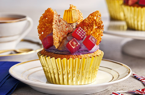 Indulge your taste buds with these decadent Coronet cupcakes! The perfect combination of vanilla sponge and rich buttercream frosting, these cupcakes are beautifully adorned with gold accents and shimmering gems.