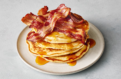 Tuck into this indulgent stack of pancakes, topped with crispy smoked bacon and drizzled with fragrant maple syrup – it makes a luxury weekend brunch for two. The pancake recipe is super-easy to follow, then it's all about the toppings!