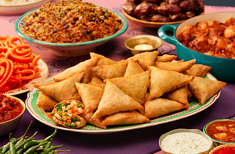 Alia is making a big batch of her famous veggie samosas for Eid tomorrow while her son Umar gets in the way beneath her feet.