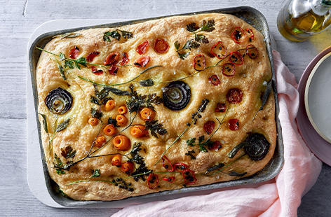 A real showstopper of a bake, decorate this golden focaccia with different herbs and veggies for a bake that looks as good as it tastes