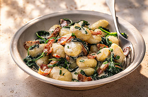 Five ingredients: One big pot of creamy gnocchi for four. Like fresh pasta, gnocchi is ready to eat in minutes. Whilst its cooking, fry the bacon until crisp, add the spinach and, once wilted stir in the Crème de Saint Agur cheese and milk then combine.