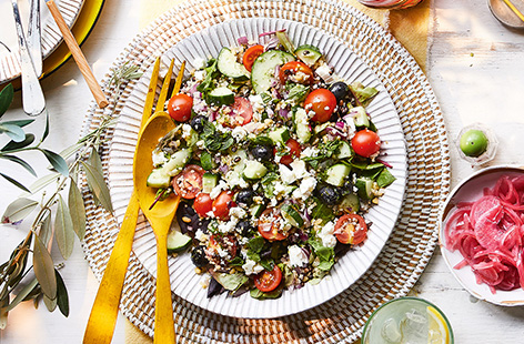 A traditional Greek salad recipe – made with tomatoes, cucumber, olives and feta – but boosted with the addition of the Fire Pit triple grain salad.