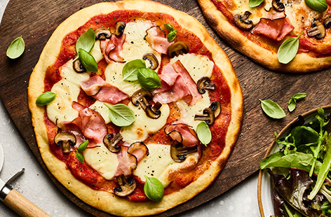 Follow the trend and make pizza at home with this simple 2-ingredient dough. Upping the protein stakes, with Greek yogurt and flour, this dough comes together really easily, requiring minimal kneading and zero proving. We've topped with ham, mushrooms and mozzarella, but of course, add your personal favourites and tuck in!