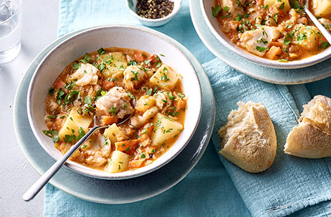Make frozen fish special with this Greek-style stew – perfect for Good Friday. Tender hake is cooked in a rich tomato sauce with potatoes and veg. Serve with crusty bread to mop up all the goodness.