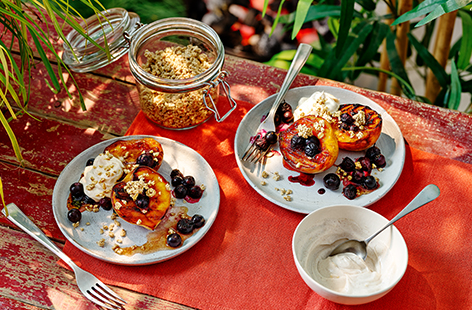 Finish off your barbecue menu with this simple seasonal pudding. Griddled peaches mixed with fresh blueberries, lemon, crunchy granola and a sprinkling of cinnamon make this dessert a winner.