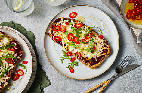 We've made cheese on toast even better! Top golden toast with grated halloumi then grill until melty. Drizzle over some hot honey, then serve with rocket. This is the ultimate WFH lunch.
