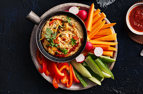 Pimp shop-bought houmous with harissa, roasted red peppers and pumpkin seeds for an impressive starter or snack.