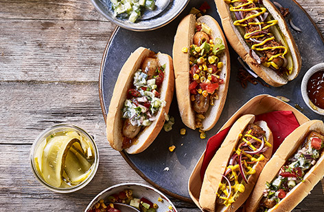Glam up classic bangers in a bun with spicy salsa, pickles and mustard, or cool raita and mango chutney for an Indian-style spin.