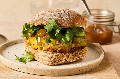 These beautifully spiced pea and potato patties show that you don't need meat to enjoy a seriously satisfying burger. Ginger, chilli and turmeric bring warmth and colour to these vegan burgers, which are fried until golden, topped with mango chutney and fresh coriander and sandwiched in a soft bun. Give this easy vegan burger recipe a go!