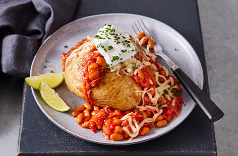 Top jacket potatoes with smoky baked beans and ham hock for an easy teatime meal