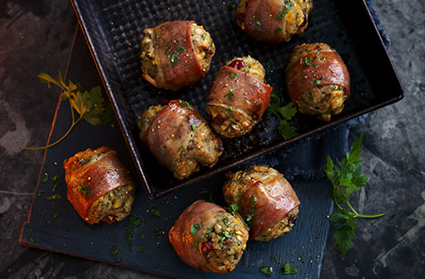 A decadent version of the classic Christmas side, these prosciutto stuffing parcels are packed full of apple, cranberry, fresh parsley and moist sausagemeat
