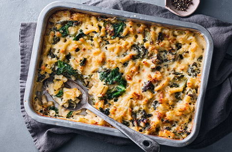 This comfort-food staple has been on quite the journey - paired with lobster, infused with truffle... Our spin is still humble and cheesy, but has been freshened up with the addition of kale. Throw together in an hour for an easy midweek dinner, or prep ahead and freeze until ready to bake.