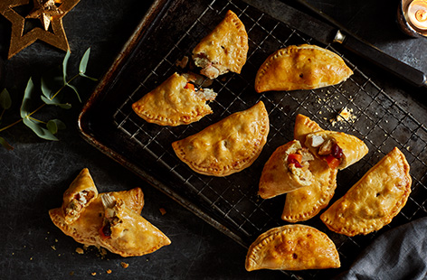 Filled with festive flavours, these half-moon chicken pasties put Christmas leftovers to good use.